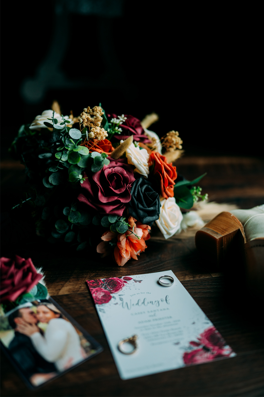 Close-up of wedding bouquet, invitations, and rings at Ever After Farms Ranch